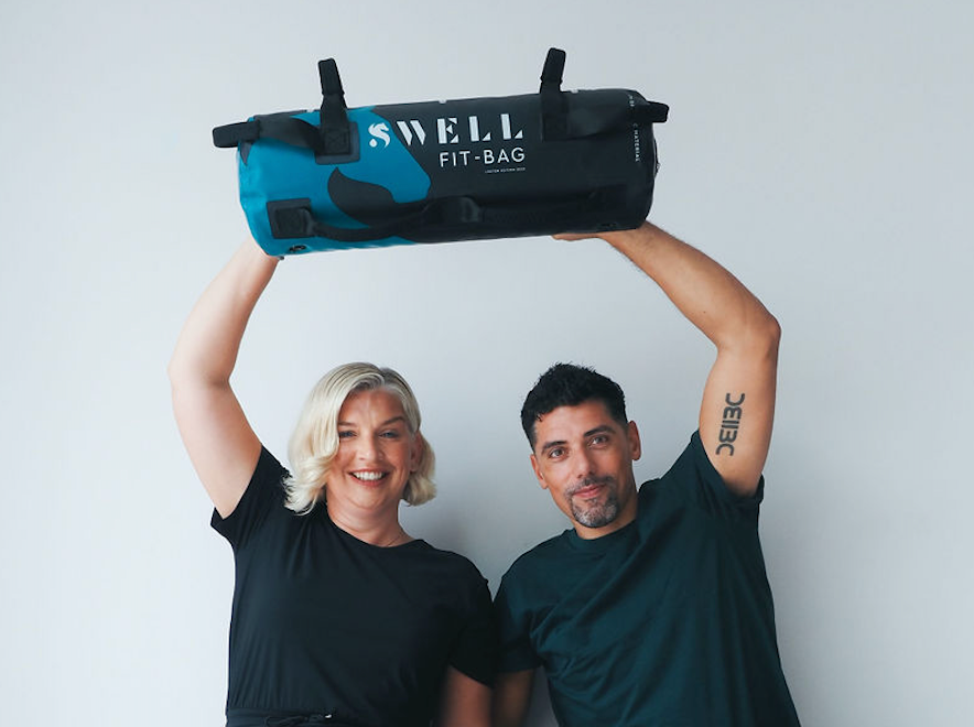Martin and Nel hold aloft the SWELL Fit Bag, founding product of SWELL Fitness